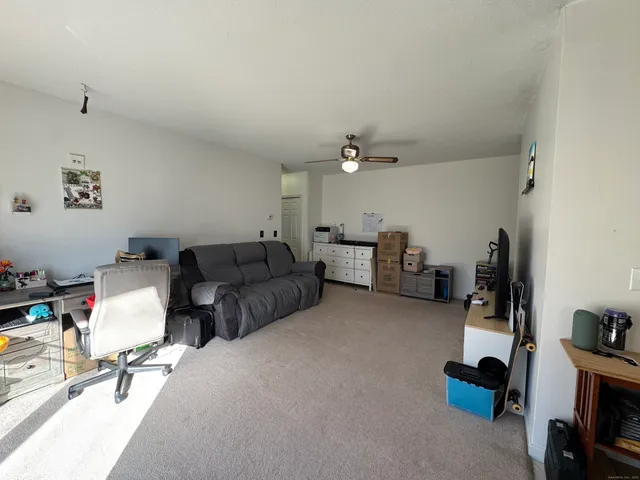 a living room with furniture and a gym equipment