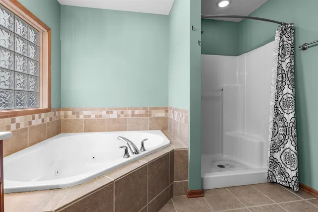 a bathroom with a bathtub and shower