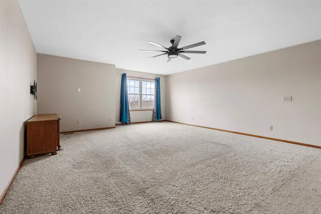 a view of a livingroom with a ceiling fan and window