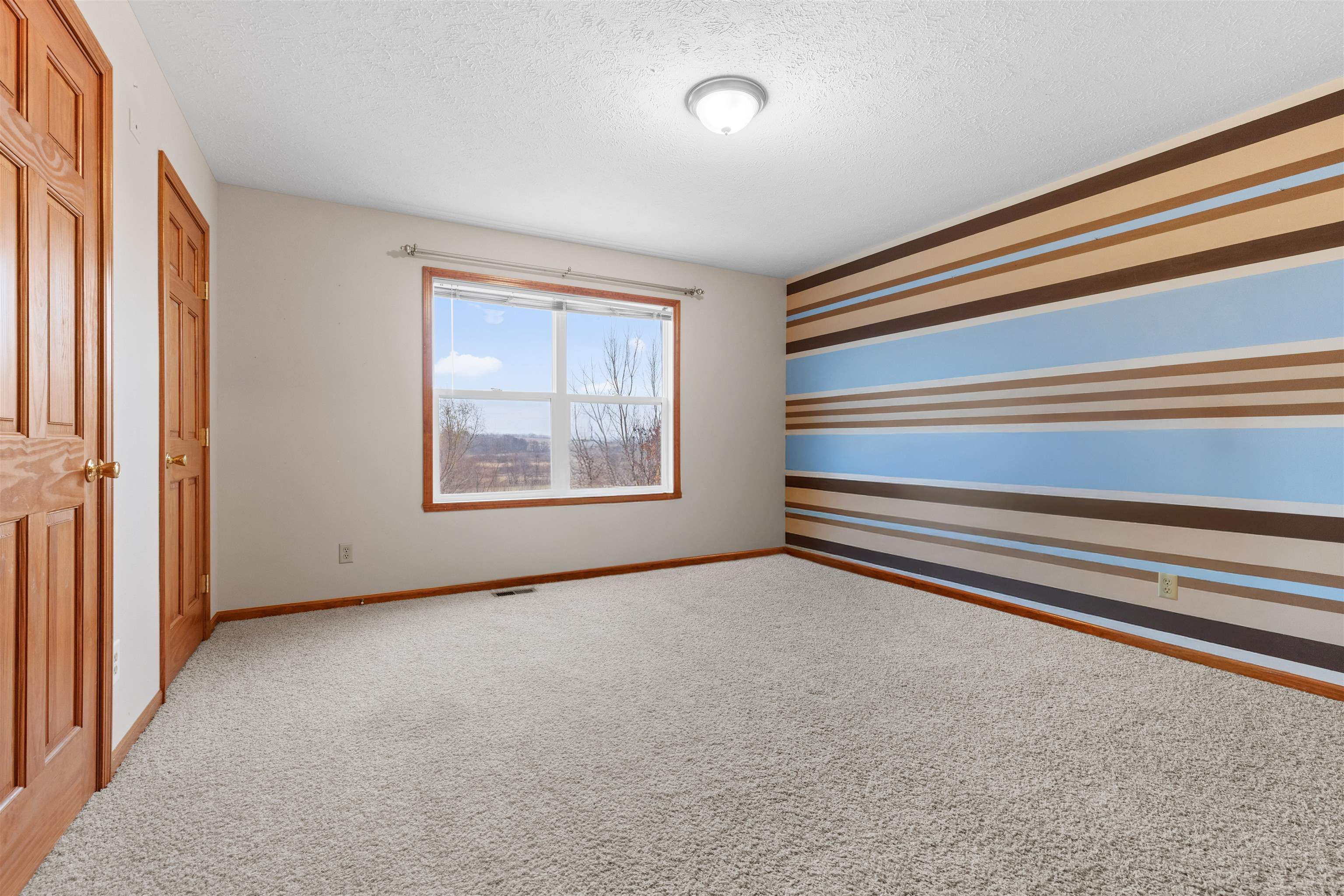8507 Crooked Bend Road Machesney Park, IL 61115 - Photo 22 of 33 a view of an empty room with a window