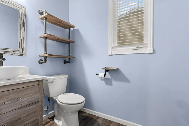 a white toilet sitting next to a bathroom sink