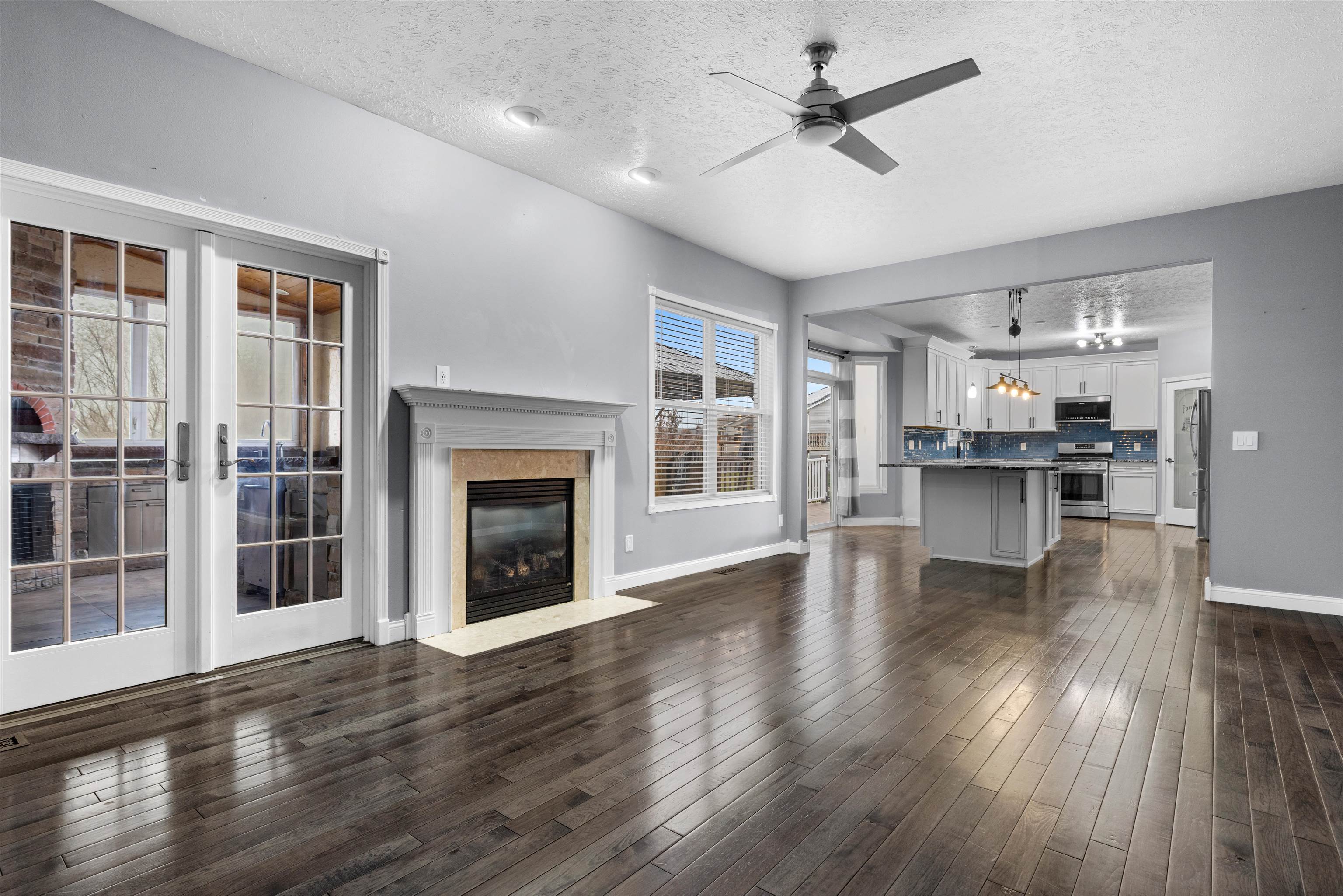 8507 Crooked Bend Road Machesney Park, IL 61115 - Photo 28 of 33 a view of a kitchen with furniture a ceiling fan and wooden floor