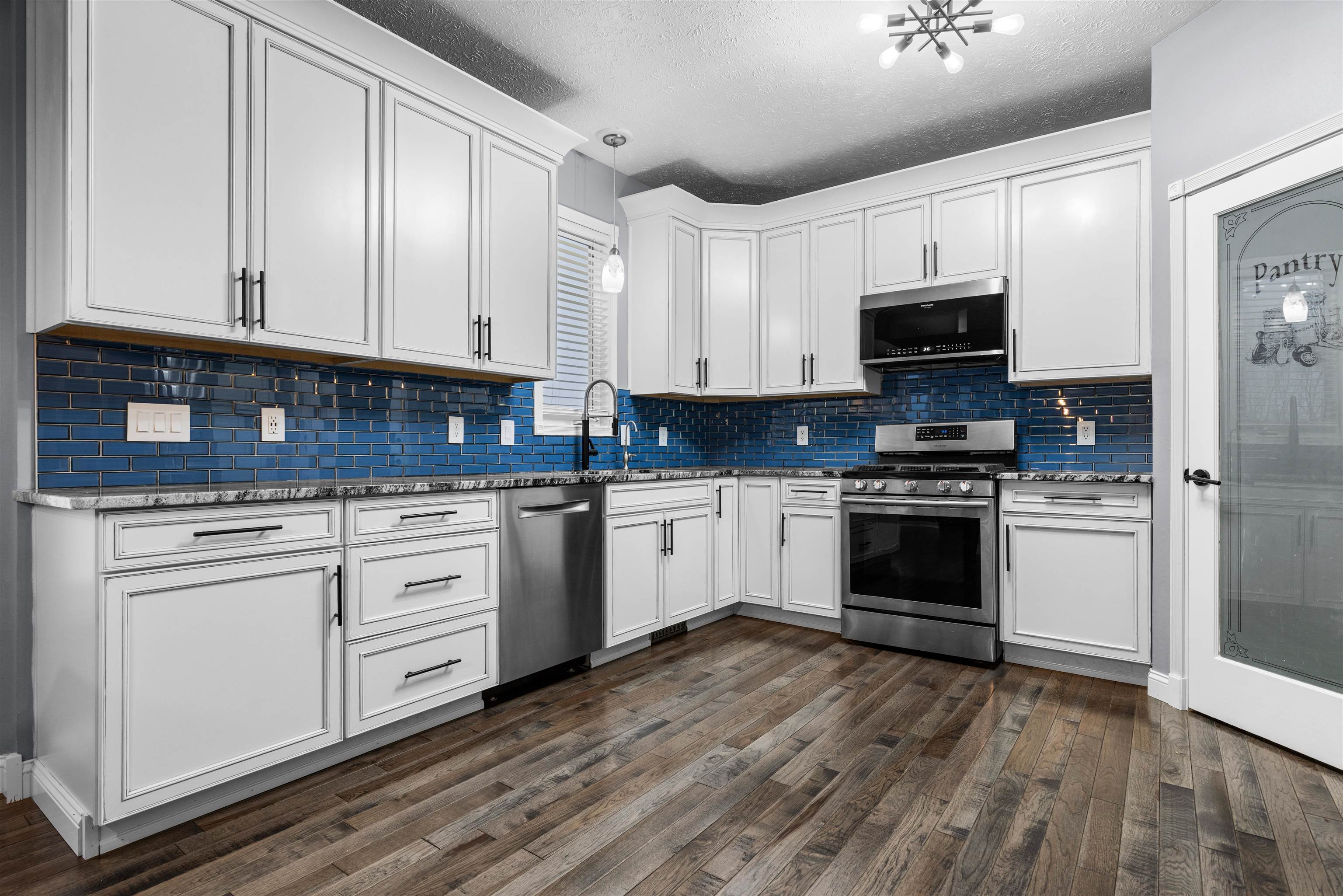 8507 Crooked Bend Road Machesney Park, IL 61115 - Photo 30 of 33 a kitchen with granite countertop white cabinets and appliances