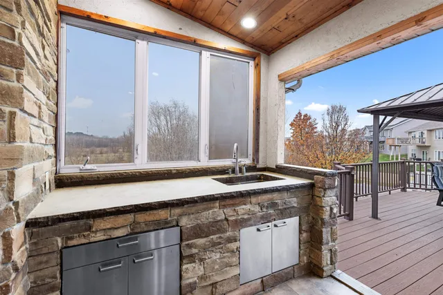 a open kitchen with a sink and wooden cabinets