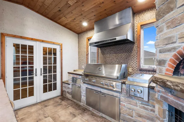 a kitchen with stainless steel appliances granite countertop a stove and a sink