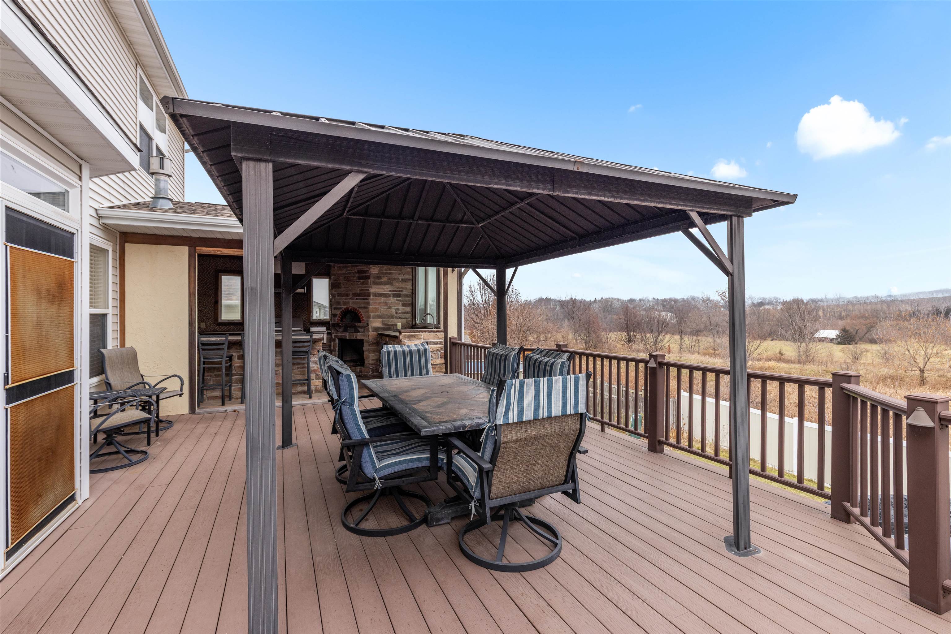 8507 Crooked Bend Road Machesney Park, IL 61115 - Photo 6 of 33 a view of a roof deck with table and chairs
