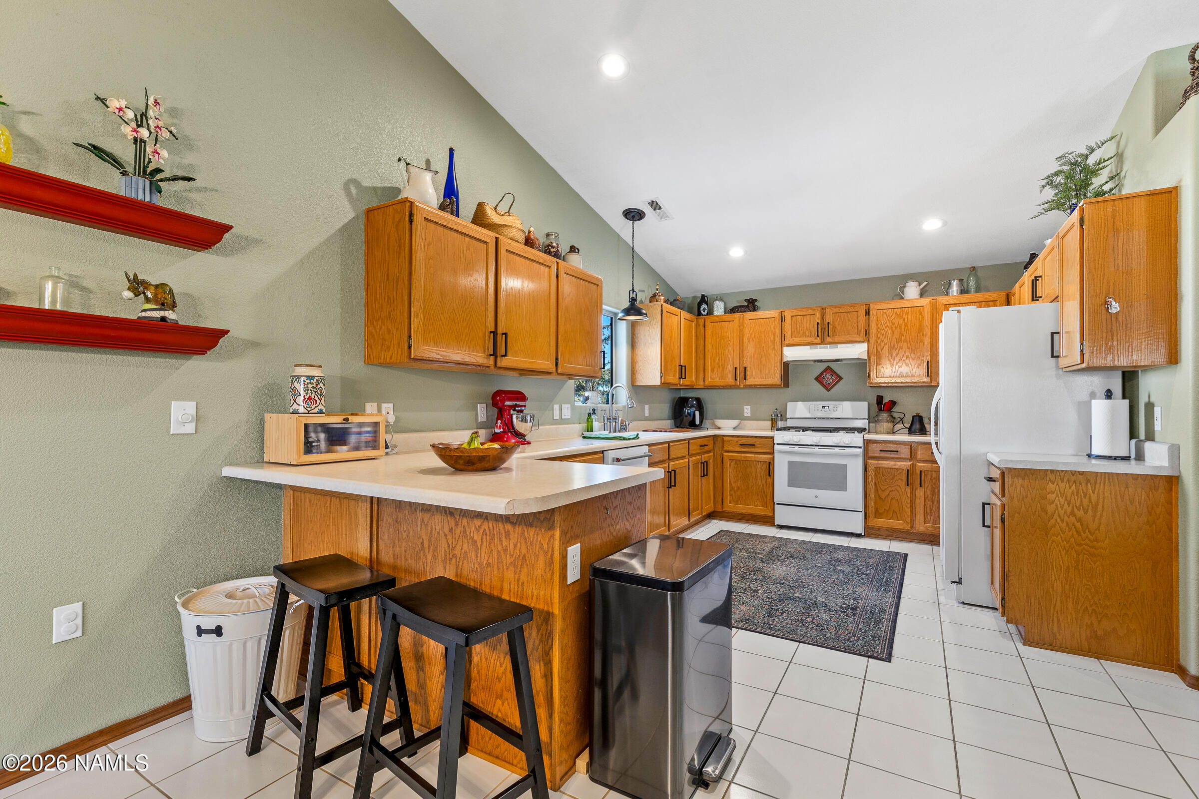 8980 Crystal View Lane Flagstaff, AZ 86004 - Photo 11 of 33 a kitchen with stainless steel appliances kitchen island granite countertop a sink and cabinets