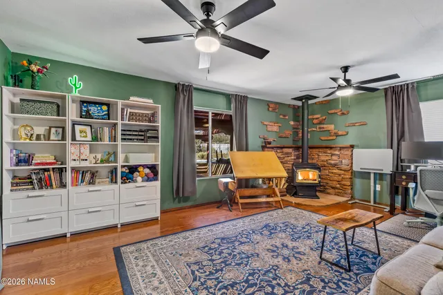 a living room with furniture and ceiling fan