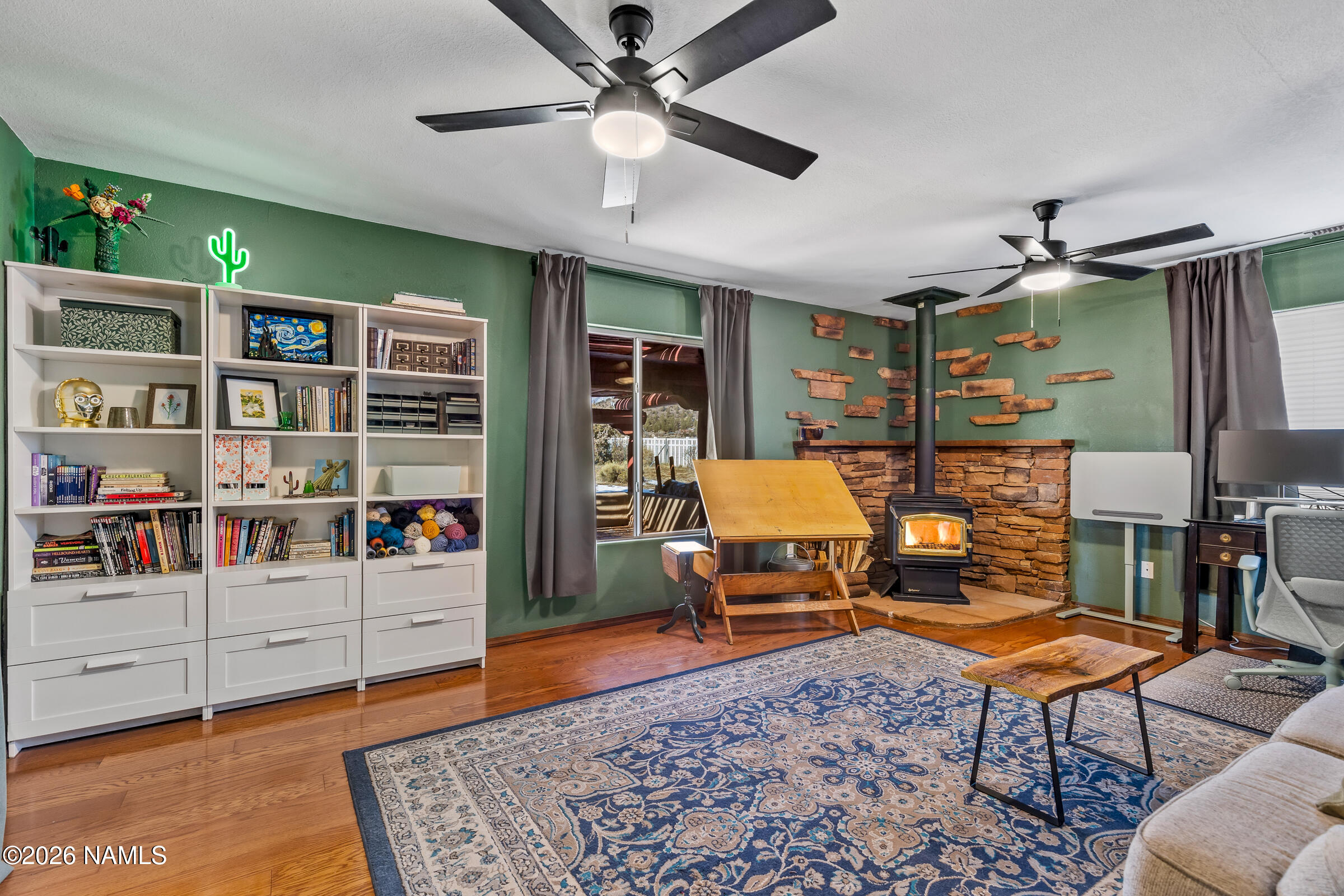8980 Crystal View Lane Flagstaff, AZ 86004 - Photo 4 of 33 a living room with furniture a rug and a bookshelf