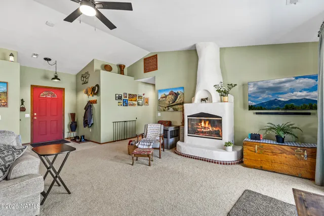 a view of a dining room with furniture and a chandelier