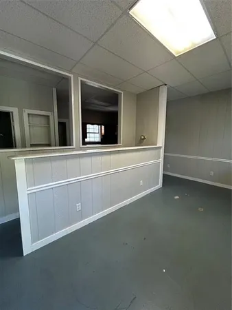 a view of a livingroom with an empty space and a window