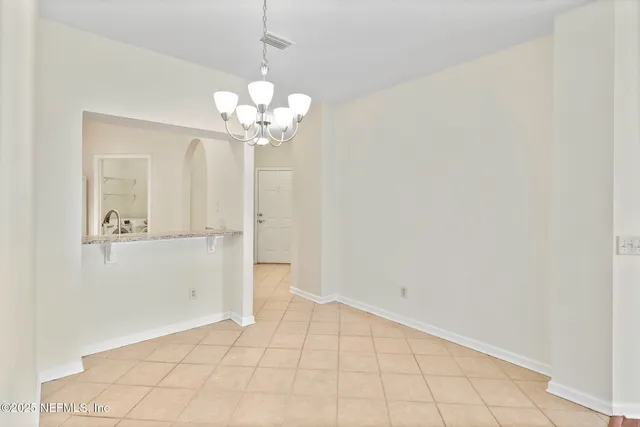 a view of a chandelier fan and entryway