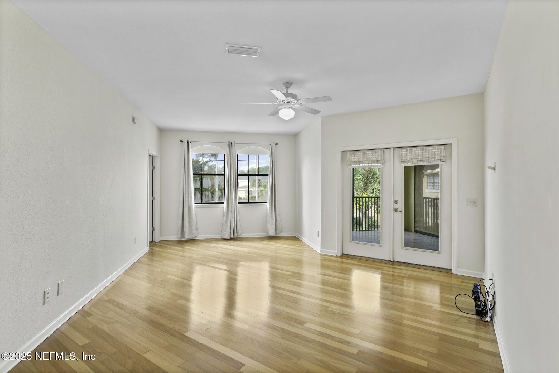 2521 Vista Cove Road St. Augustine, FL 32084 - Photo 13 of 64 a view of an empty room with a window and wooden floor