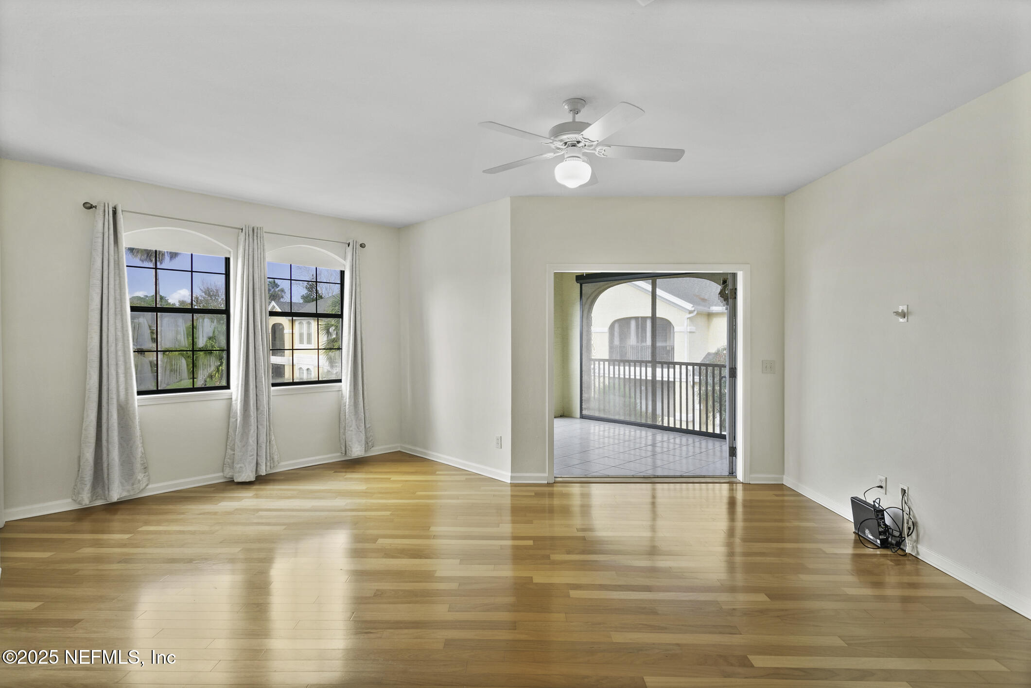 2521 Vista Cove Road St. Augustine, FL 32084 - Photo 16 of 64 a view of empty room with wooden floor and fan