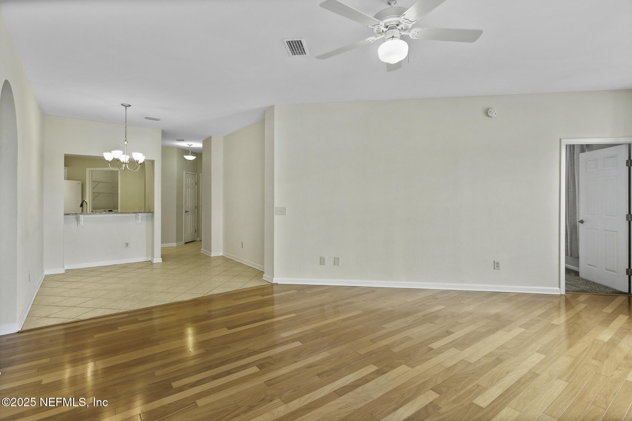 2521 Vista Cove Road St. Augustine, FL 32084 - Photo 21 of 64 a view of an empty room with wooden floor and a ceiling fan