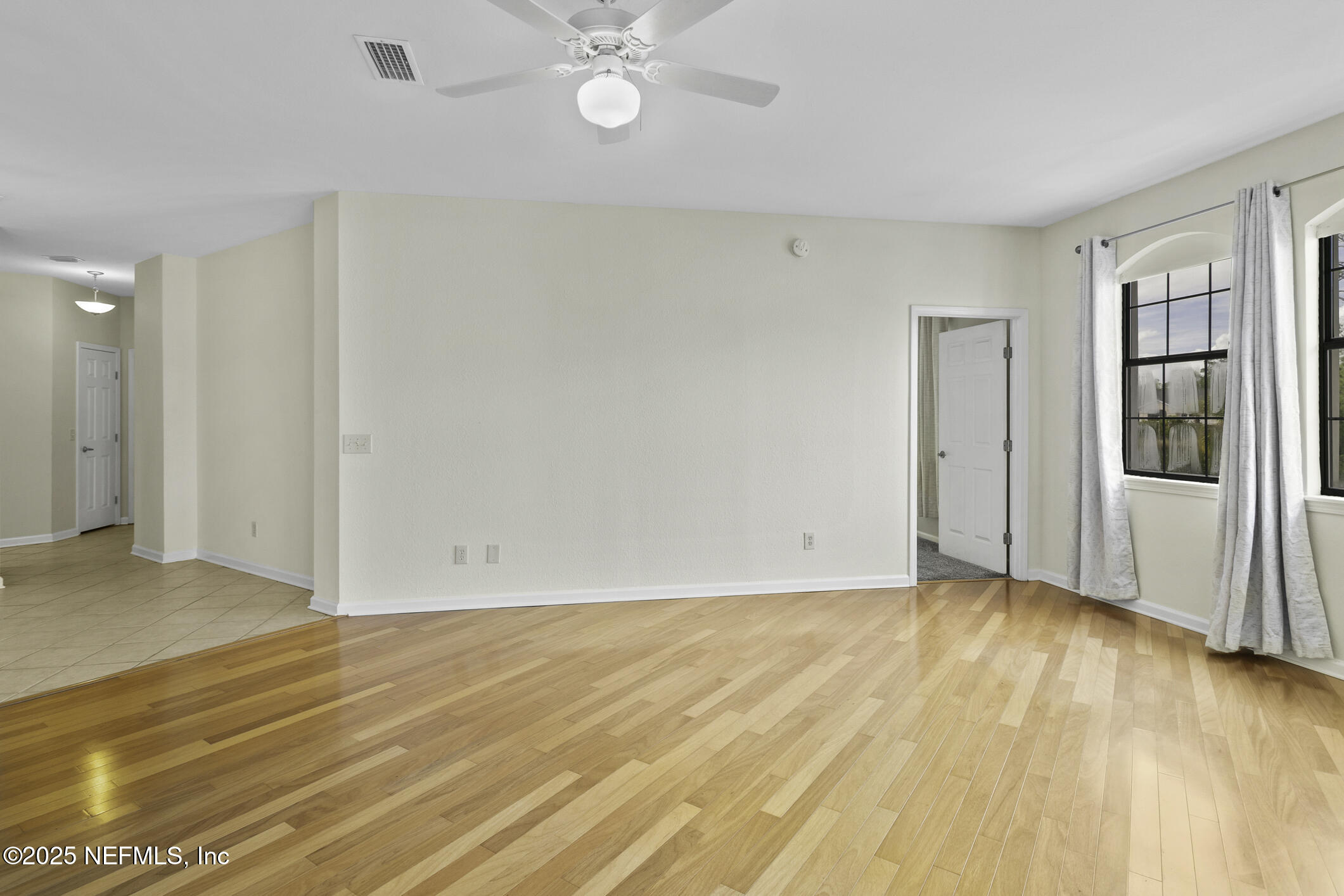 2521 Vista Cove Road St. Augustine, FL 32084 - Photo 22 of 64 a view of an empty room with wooden floor and a window