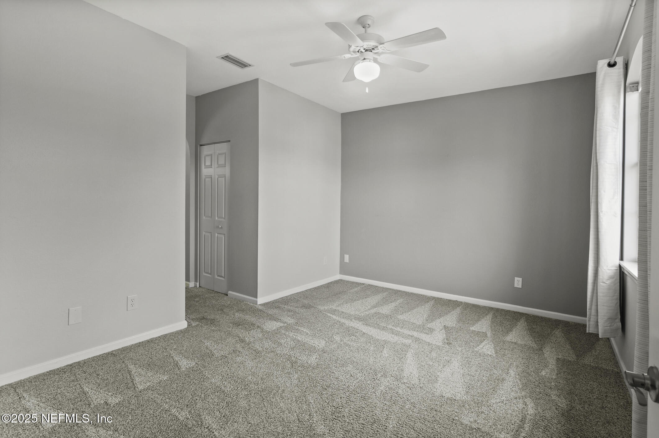2521 Vista Cove Road St. Augustine, FL 32084 - Photo 23 of 64 an empty room with a ceiling fan and a window