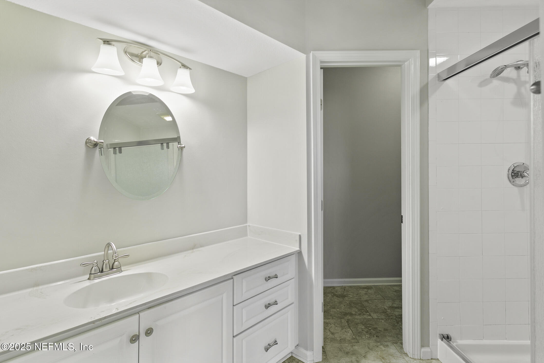 2521 Vista Cove Road St. Augustine, FL 32084 - Photo 27 of 64 a bathroom with a sink a mirror and shower