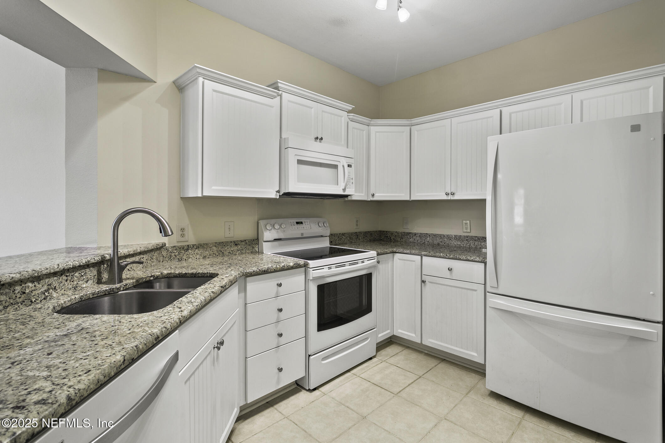 2521 Vista Cove Road St. Augustine, FL 32084 - Photo 3 of 64 a kitchen with white cabinets sink and white appliances
