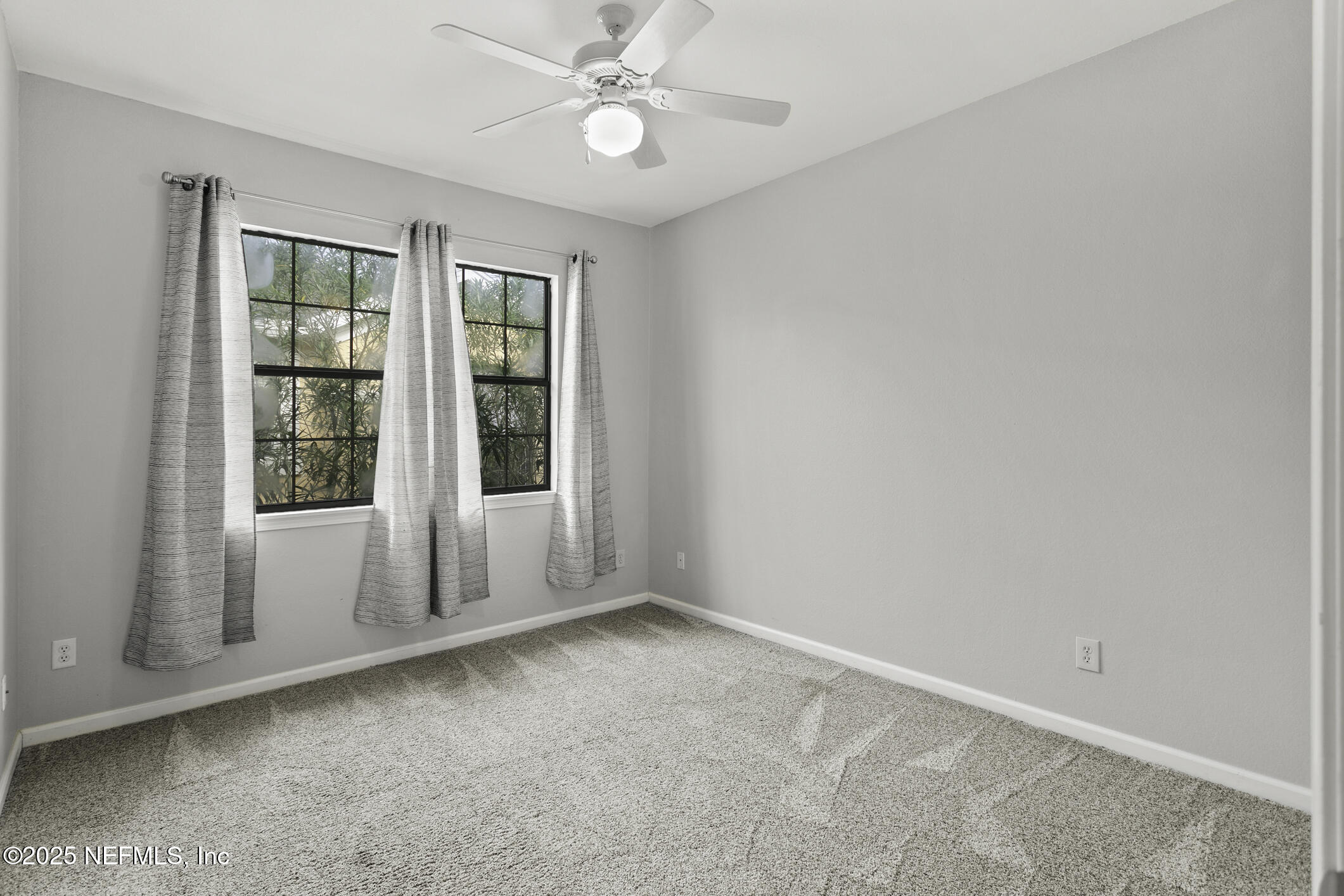 2521 Vista Cove Road St. Augustine, FL 32084 - Photo 31 of 64 an empty room with windows and fan