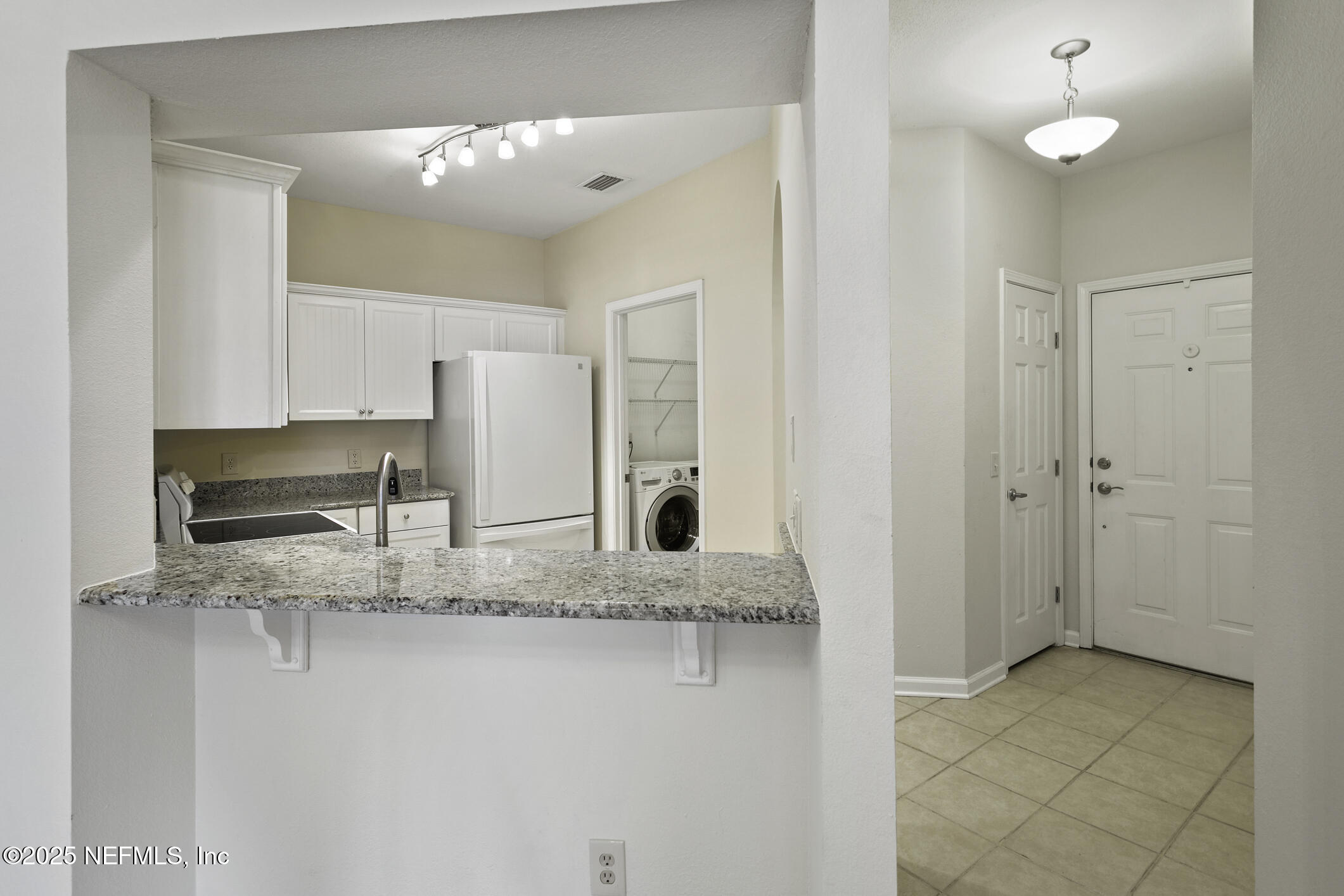 2521 Vista Cove Road St. Augustine, FL 32084 - Photo 8 of 64 a kitchen with stainless steel appliances granite countertop a sink and a granite counter tops