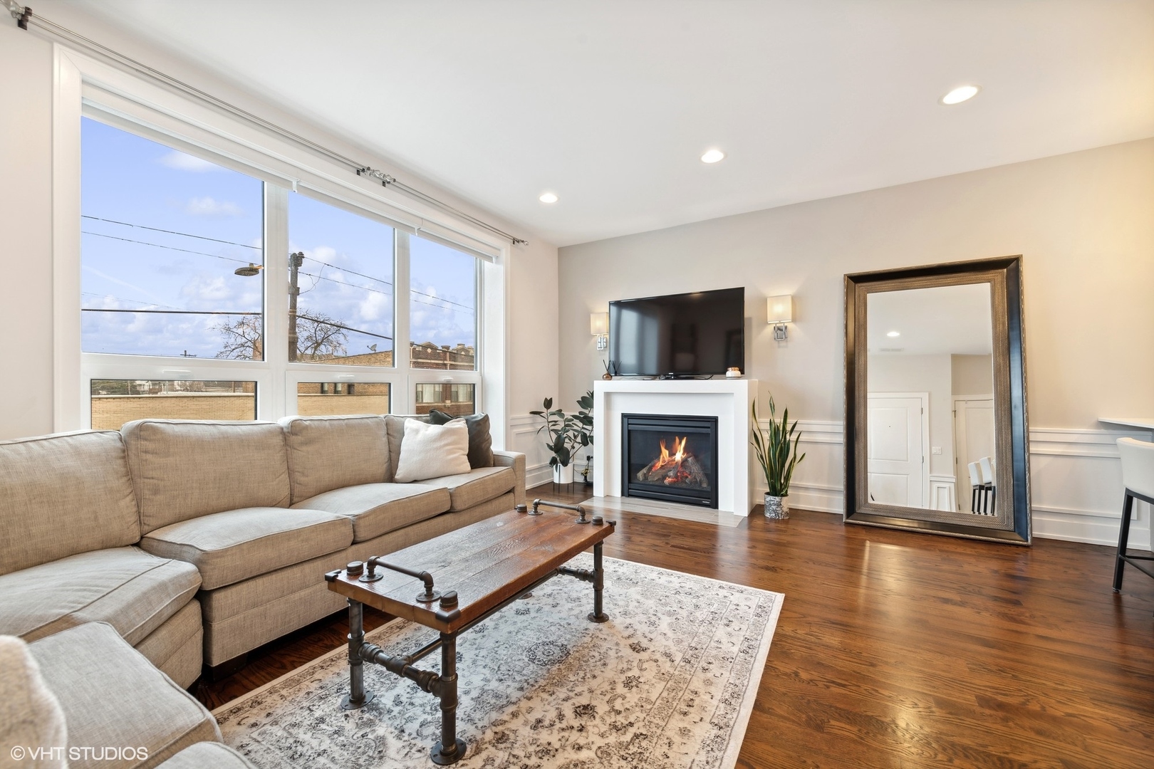 3003 North California Avenue, Unit 2N Chicago, IL 60618 - Photo 3 of 17 a living room with furniture a fireplace and a table