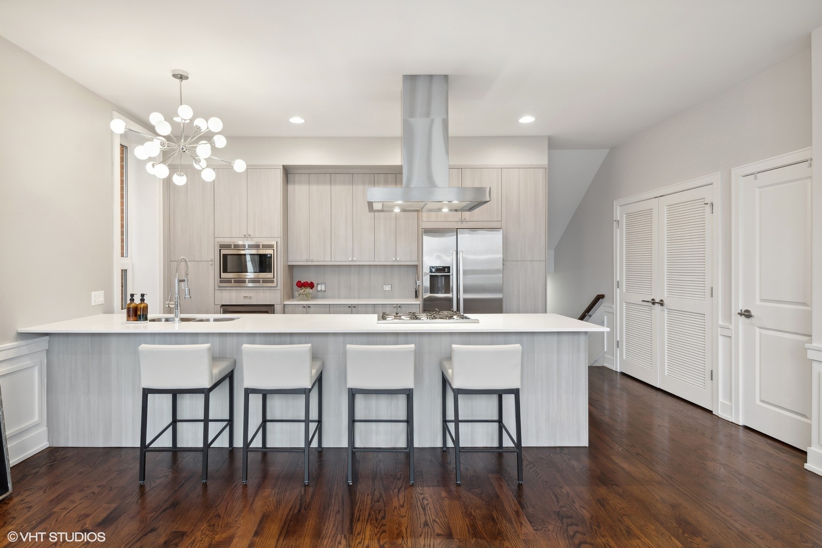 3003 North California Avenue, Unit 2N Chicago, IL 60618 - Photo 5 of 17 a kitchen with kitchen island granite countertop a sink and white cabinets