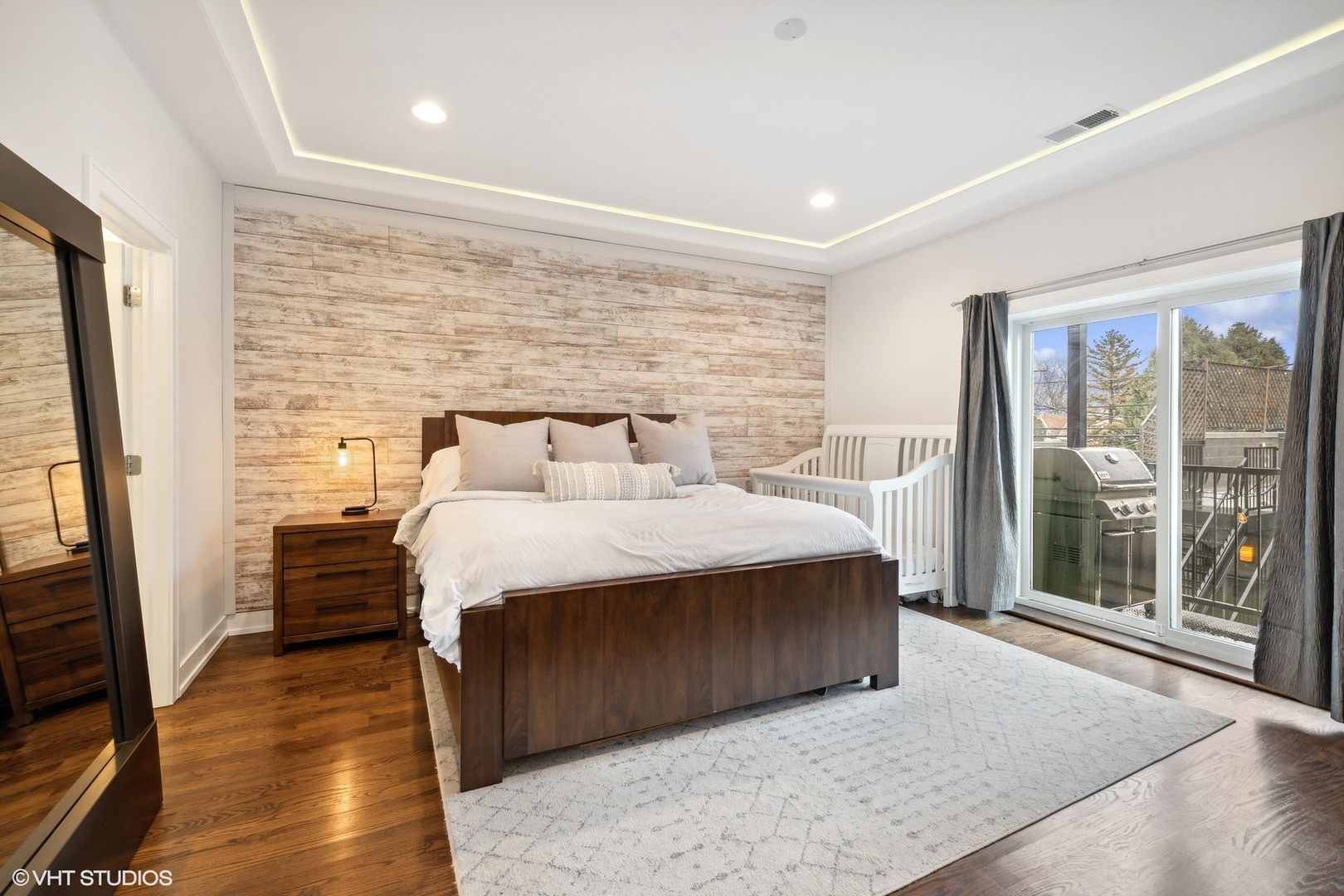 3003 North California Avenue, Unit 2N Chicago, IL 60618 - Photo 8 of 17 a bedroom with a bed and wooden floor