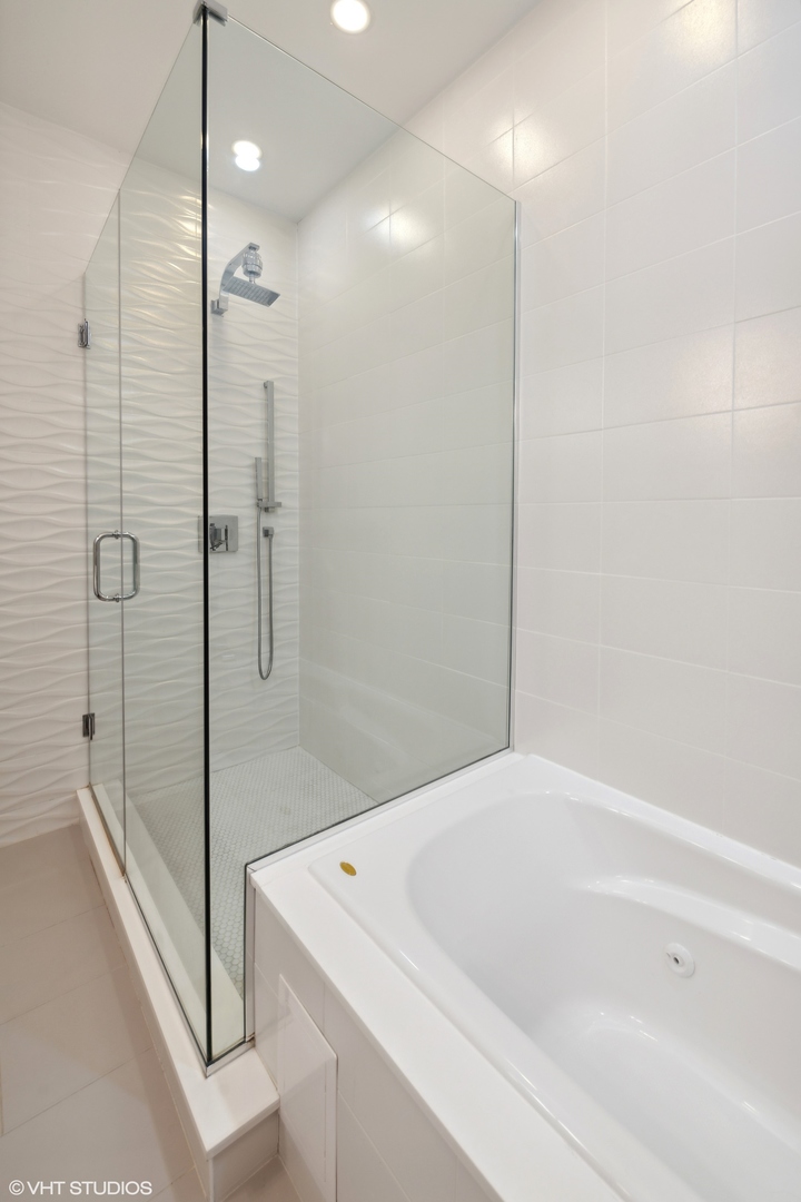 3003 North California Avenue, Unit 2N Chicago, IL 60618 - Photo 10 of 17 a bathroom with a bathtub and a shower