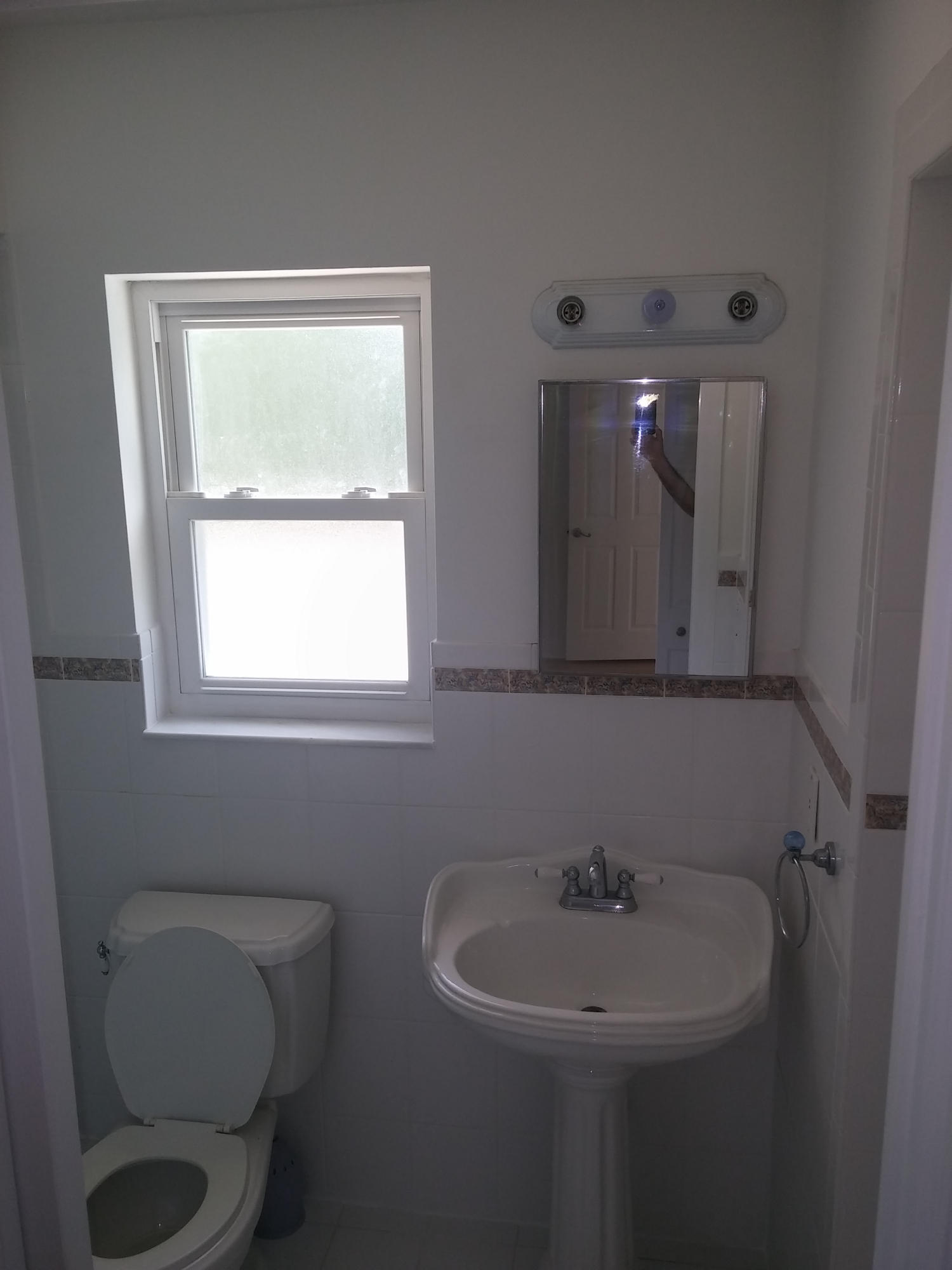 29 Tam O Shanter Lane Boca Raton, FL 33431 - Photo 12 of 18 a bathroom with a toilet a sink and mirror