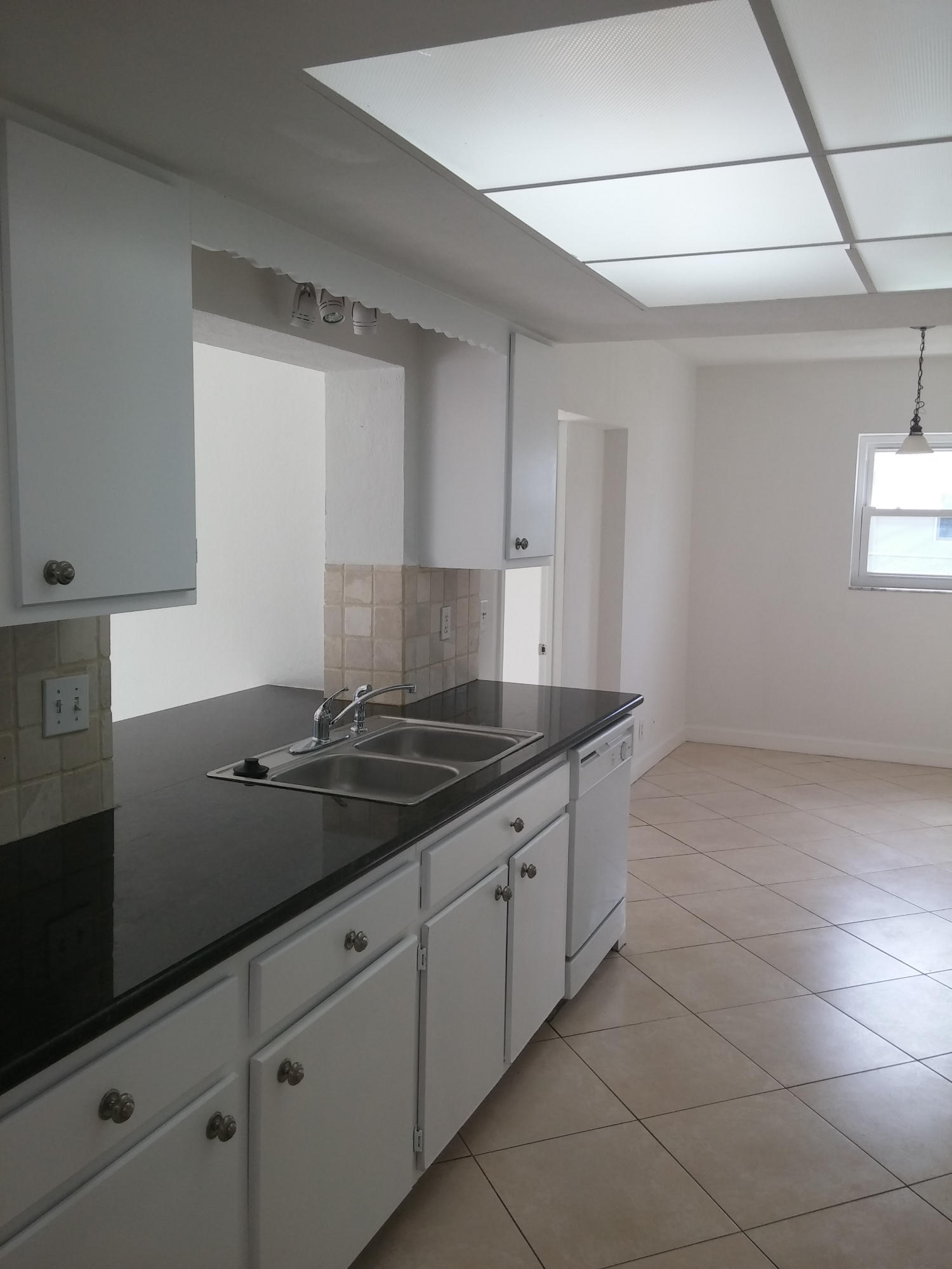 29 Tam O Shanter Lane Boca Raton, FL 33431 - Photo 5 of 18 a kitchen with a sink and cabinets