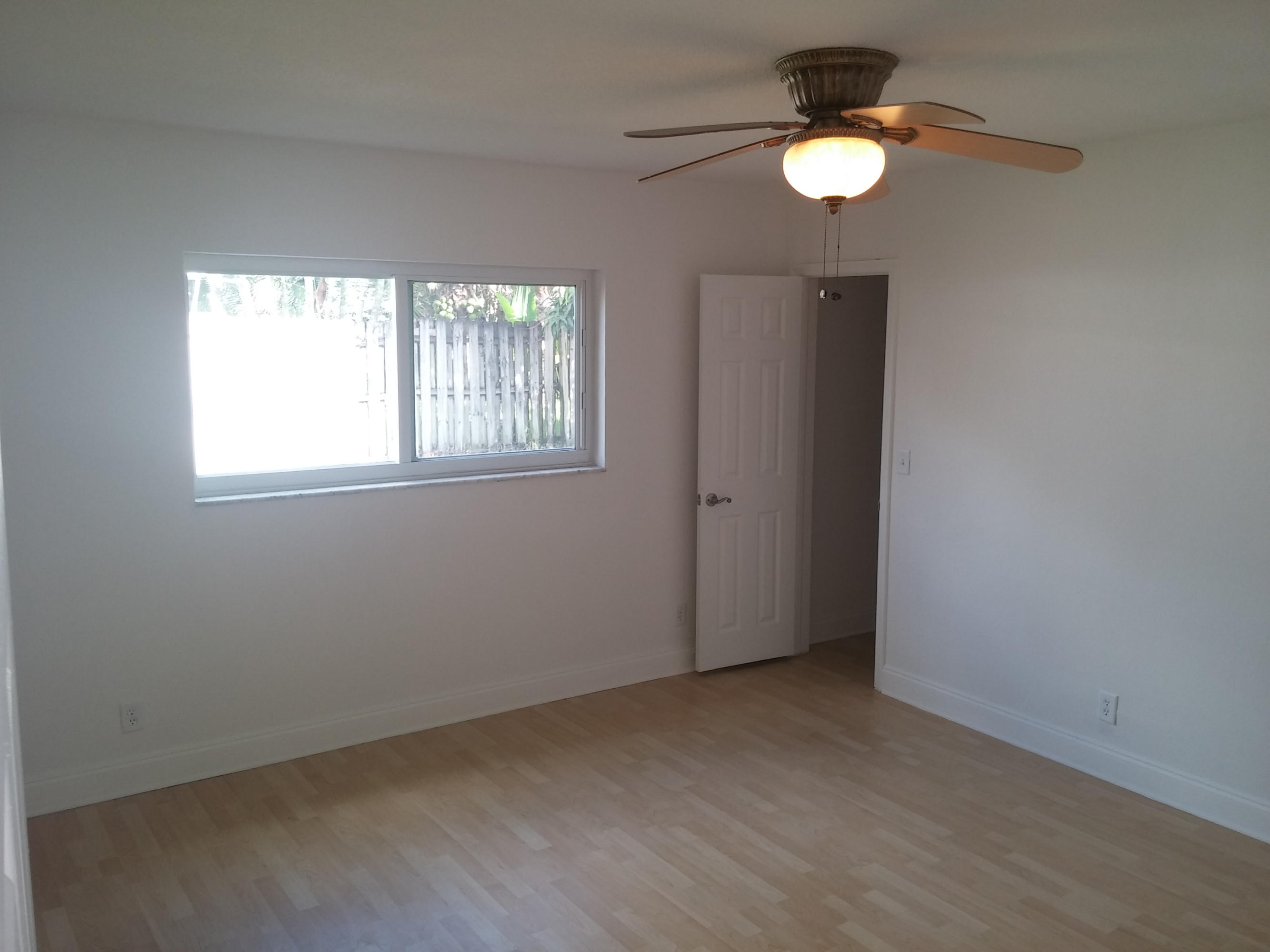 29 Tam O Shanter Lane Boca Raton, FL 33431 - Photo 10 of 18 an empty room with windows and fan
