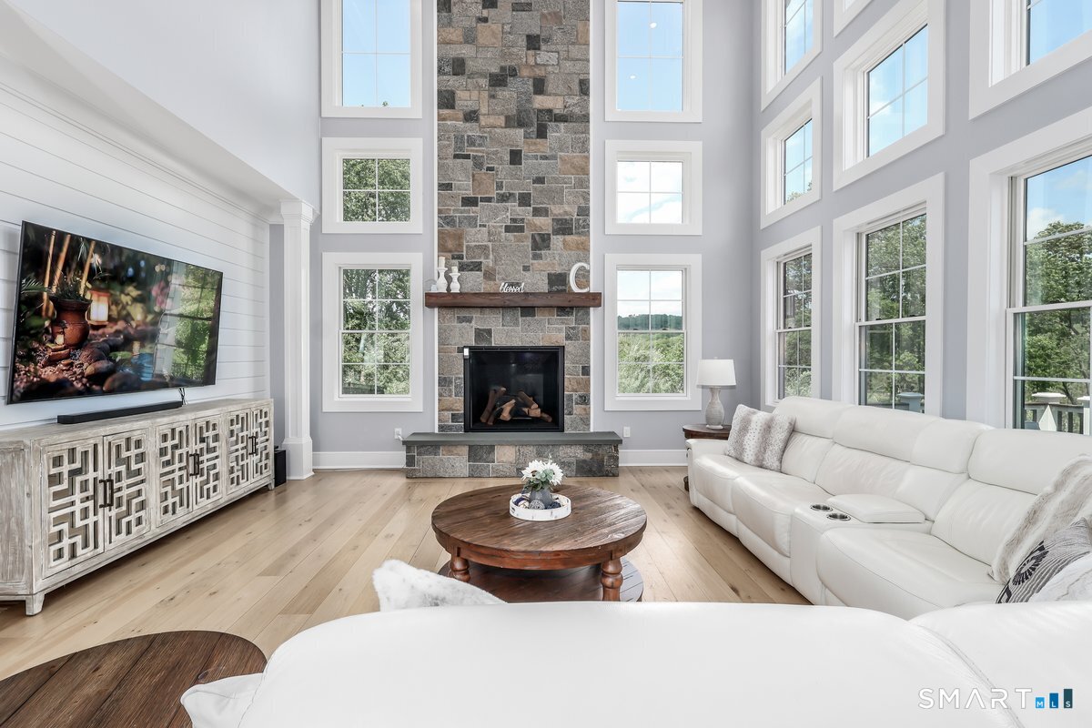 2 Pond View Lane Sherman, CT 06784 - Photo 7 of 40 a living room with furniture a fireplace and a flat screen tv