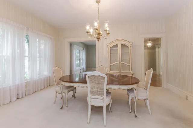 a view of a dining room with furniture and chandelier