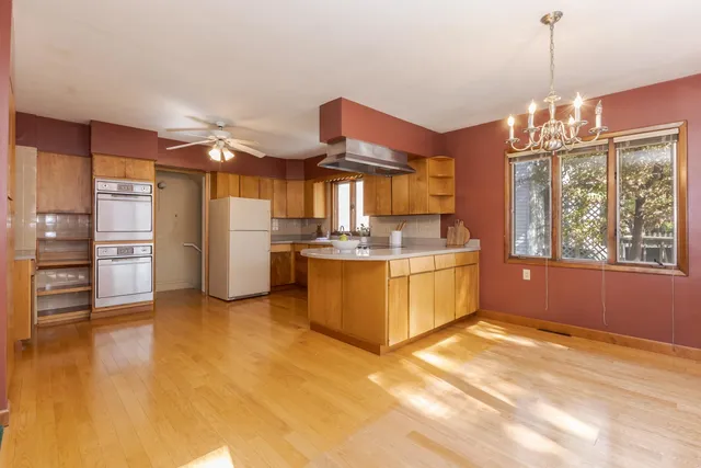 a kitchen with refrigerator and cabinets