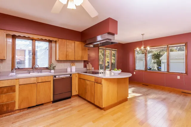 a view of an empty room with window and stairs