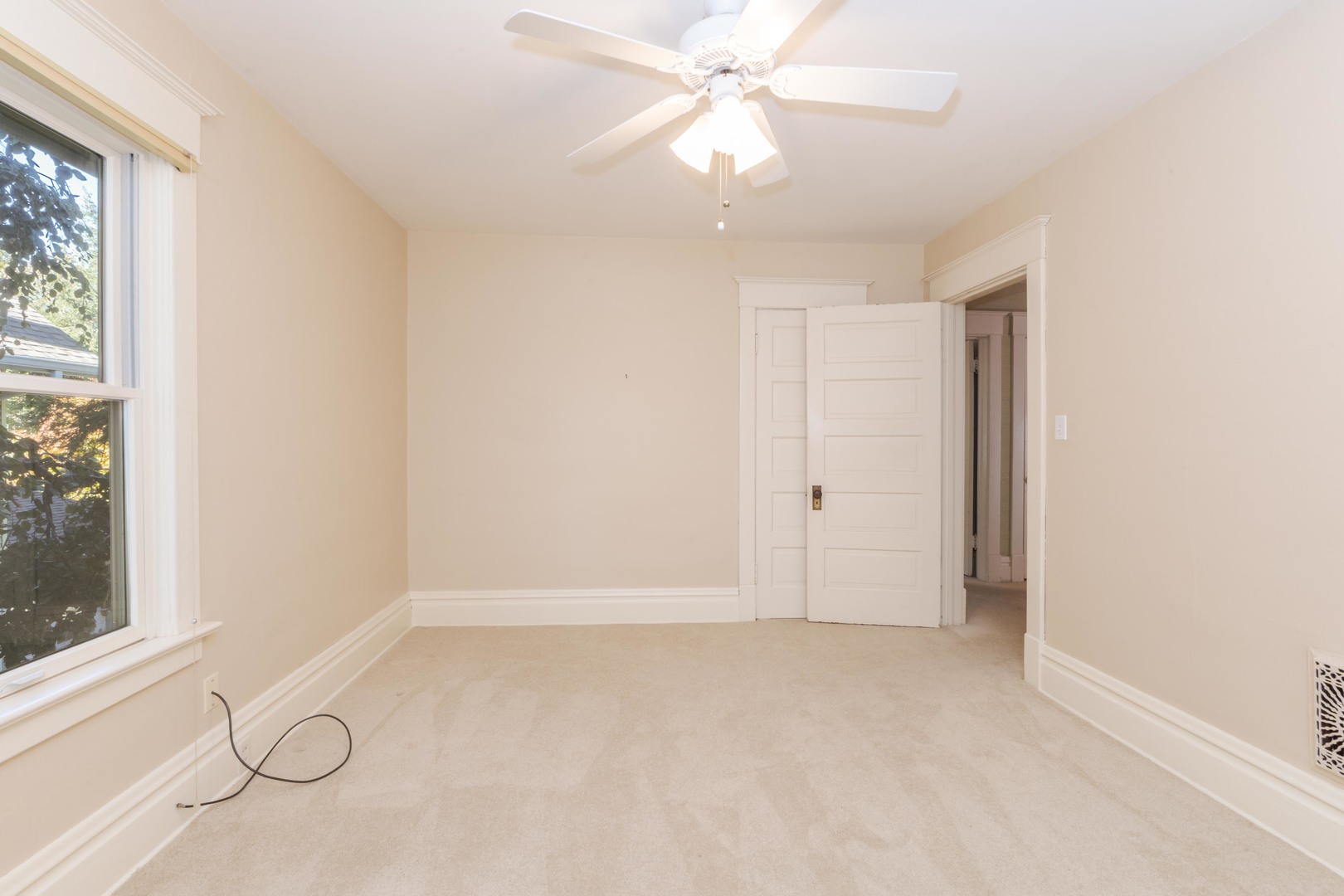 1513 East Grove Street Bloomington, IL 61701 - Photo 29 of 48 an empty room with windows and fan