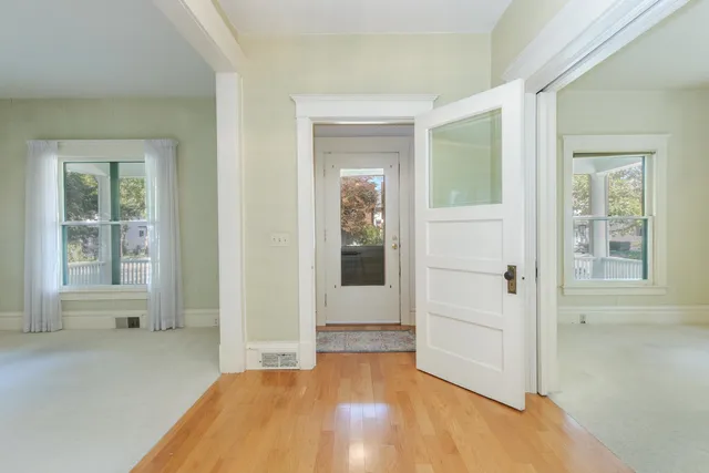 an empty room with windows and closet
