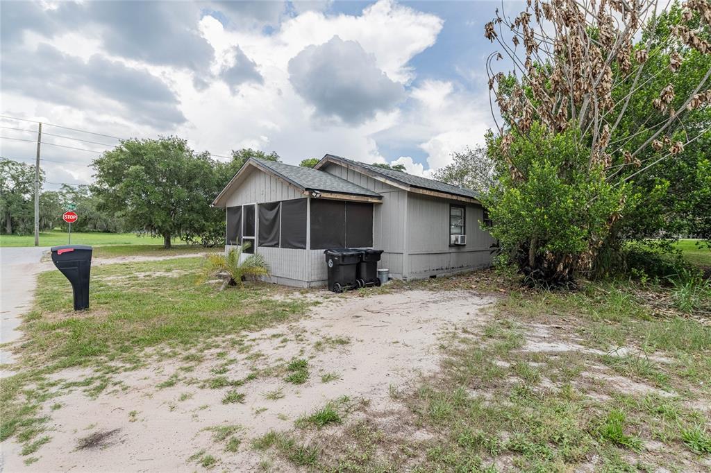 5 North Street Frostproof, FL 33843 - Photo 3 of 22 a view of a house with backyard and trees