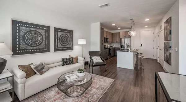 a living room with furniture and a wooden floor