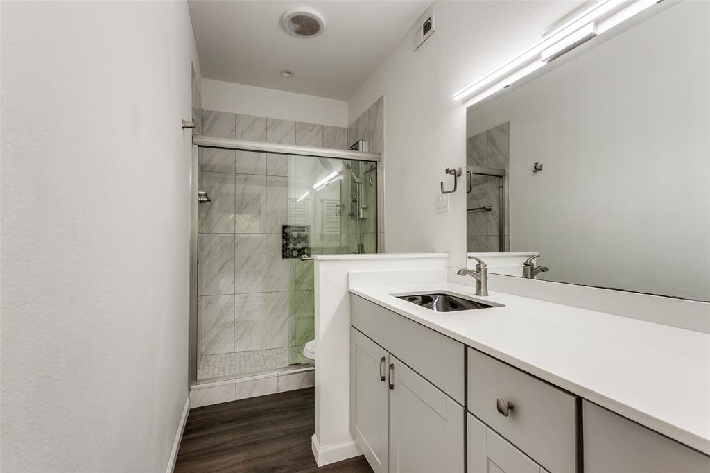 8601 Park Lane, Unit 111 Dallas, TX 75231 - Photo 13 of 18 a bathroom with a sink and a mirror