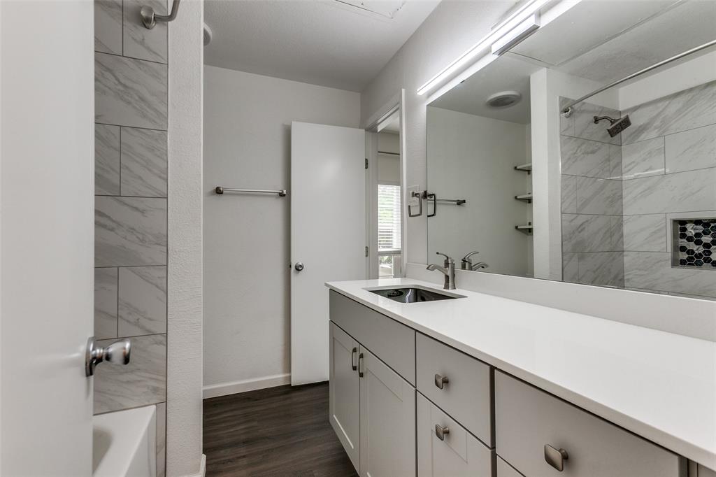 8601 Park Lane, Unit 111 Dallas, TX 75231 - Photo 16 of 18 a bathroom with a sink and a mirror