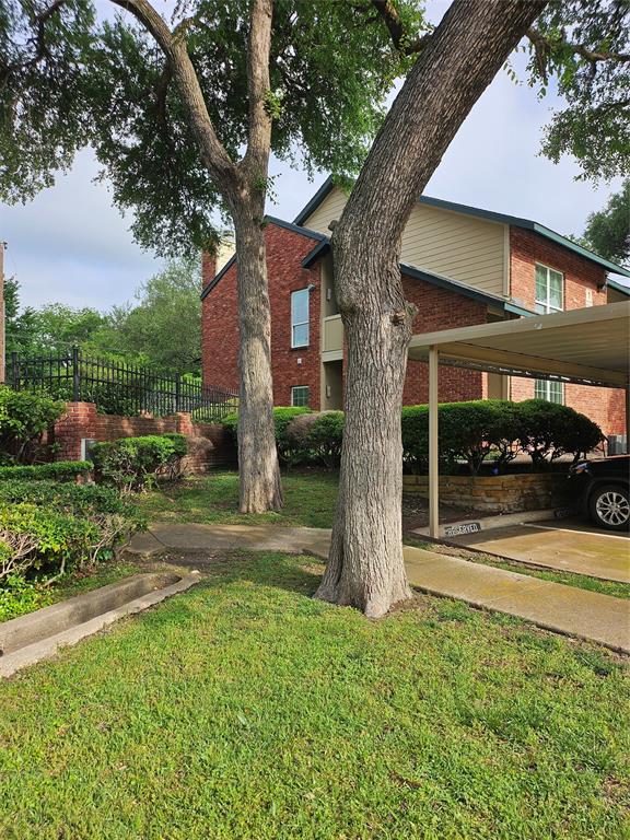 8601 Park Lane, Unit 111 Dallas, TX 75231 - Photo 18 of 18 a view of a house with a yard