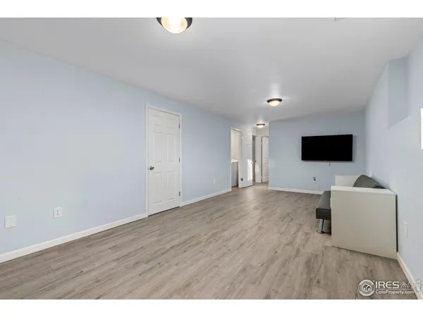 a view of an empty room and wooden floor