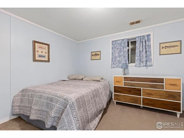 a bedroom with a bed and a cabinets