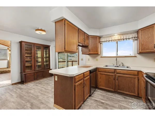 a kitchen with a sink stove and cabinets