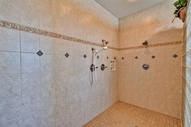 a view of a dining room and livingroom with furniture wooden floor a rug and a chandelier