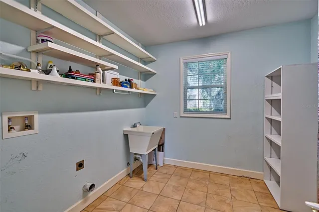 a view of a house with a big yard and large trees