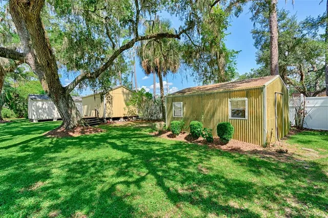 a front view of a house with yard and green space