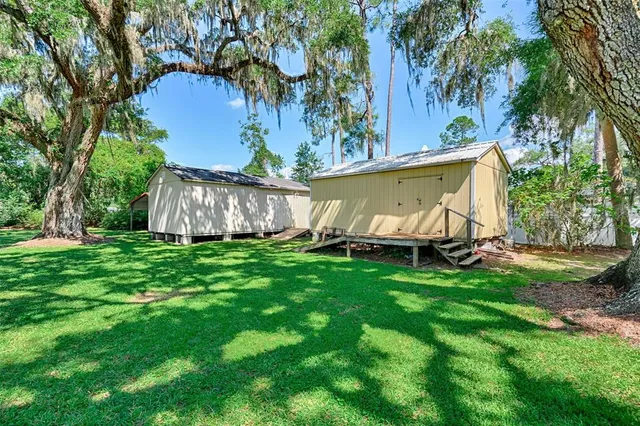 a aerial view of a house with a yard table and chairs